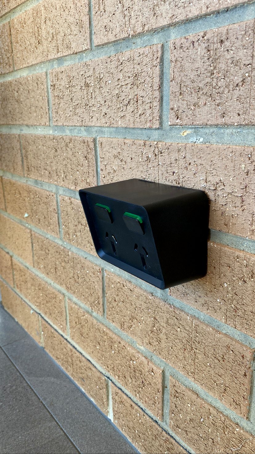Weatherproof double power point freshly installed on an exterior brick wall